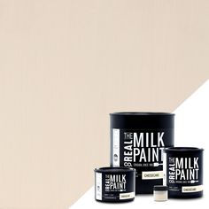 three cans of milk paint on an orange and white background