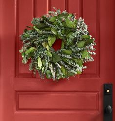 a red door with a wreath hanging on it