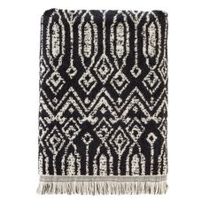 a black and white rug with fringes