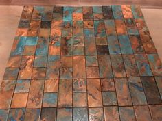 a tile floor with blue and brown tiles on it