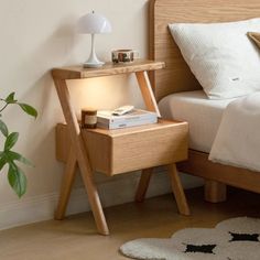 a bed with a wooden frame and night stand next to it on top of a carpeted floor