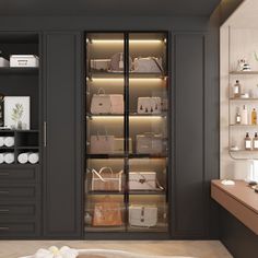 a bathroom with black cabinets and white towels on the counter top, along with various handbags