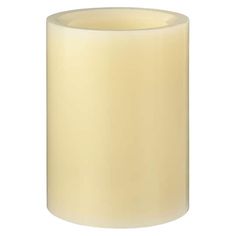 a white candle is lit on a white background