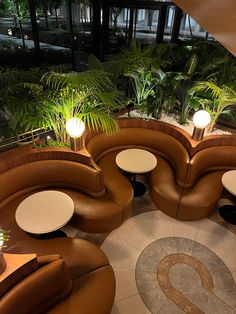 an overhead view of a restaurant with couches, tables and plants in the corner