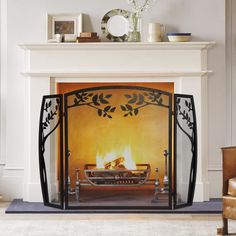 a fireplace with a fire in it next to a chair