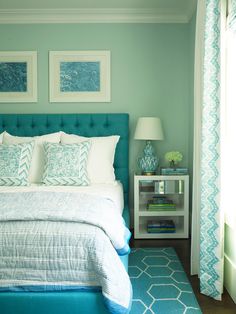 a bedroom with blue and white decor on the walls