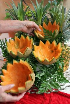 the pineapples are cut in half and placed on top of each other with green leaves