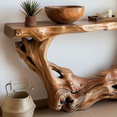 a wooden table sitting on top of a tiled floor next to a potted plant