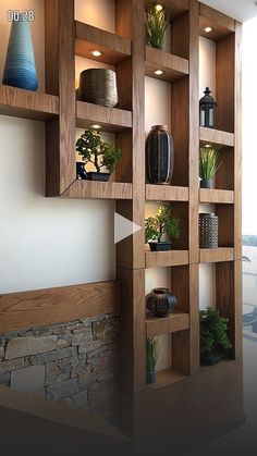 a wooden shelf filled with lots of different types of potted plants on top of it