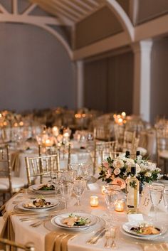 the tables are set with white and gold linens for an elegant wedding reception at the grand america hotel