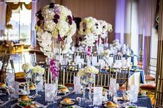 the tables are set up with flowers and place settings for an elegant dinner or reception