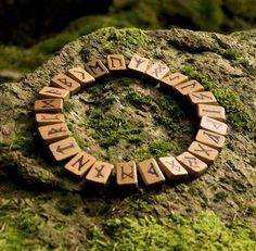 a close up of a rock with some type of word written in wooden letters on it