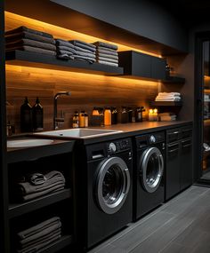 a washer and dryer in a room with wooden shelves on the wall next to each other