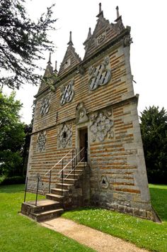 an old brick building with many windows on it's side and stairs leading up to the door