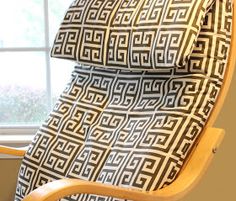 an upholstered chair in front of a window