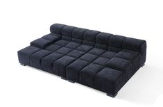 a black couch sitting on top of a white floor