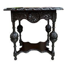 an ornate wooden table with marble top and carved details on the legs, against a white background