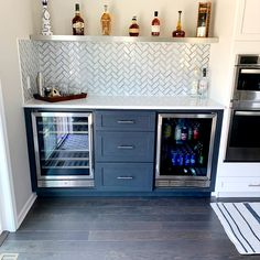 a kitchen with an oven, refrigerator and wine cooler