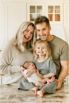 a man, woman and child are smiling for the camera