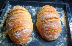 two loaves of bread sitting on top of a baking sheet with the words click here for the recipe