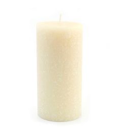 a white pillar candle on a white background