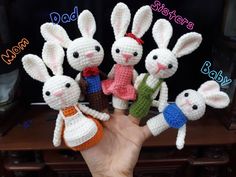 crocheted rabbits are in the palm of someone's hand