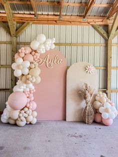 balloons and flowers are arranged in front of a large sign that reads,'alja '