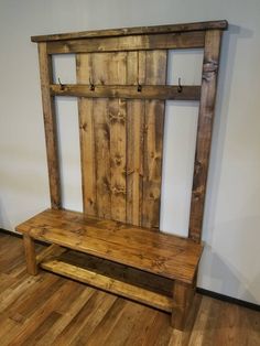 a wooden bench sitting on top of a hard wood floor