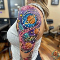 a woman's arm with an image of the planets and stars painted on it