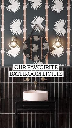 a bathroom with black and white tiles, a round sink and two mirrors on the wall