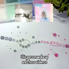 a table topped with lots of different types of beads and greeting cards next to a window