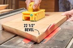 a person using a table saw to cut planks on a wooden board with a measuring tape