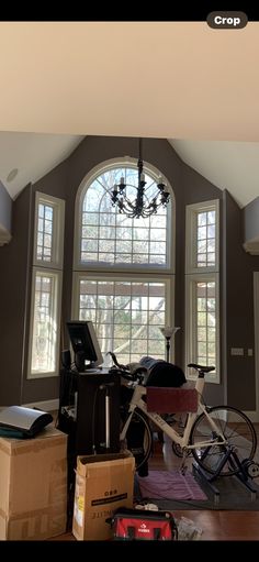 a living room filled with lots of furniture and a chandelier hanging from the ceiling