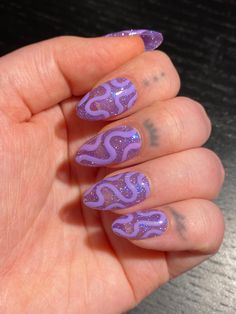 "High quality press on nails. This set features a slightly sheer purple \"jelly\" glitter that reflects iridescent based on the lighting, with a subtle wavy line design that is more prominent based on lighting. Nails pictured are SHORT ALMOND shape. Photos show the nails photographed in different lighting to give the best possible representation (natural lighting, sunlight, and with flash). PLEASE READ: Use the nail sizing chart instructions from the photos to measure your nails. Then choose from the nail size options XS, S, M, or L. If your nails do not fit the standard sizes and you need custom sizing, please choose \"CUSTOM\" sizing and type in your custom sizes from thumb to pinky (ie. 1, 2, 3, 4, 5) under the \"personalization\" option. Please choose your length and shape. You can fin Trending Purple Nails, Lilac Purple Short Nails, Birthday Asthetic Nails, Long Nail Shape Ideas, Purple And Leopard Nails, Wiggly Nail Designs, Abstract Glitter Nails, Queer Nail Art Designs, Glitter Squiggle Nails