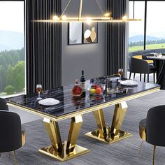 a dining room table with black chairs and gold accents