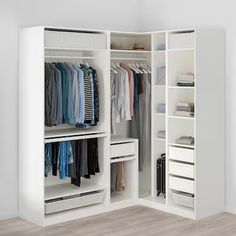 a white closet filled with lots of clothes