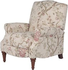 a chair with floral fabric and wooden legs