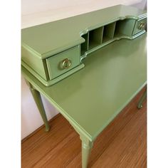 a green desk with two drawers on it