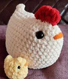 a crocheted chicken with a small teddy bear