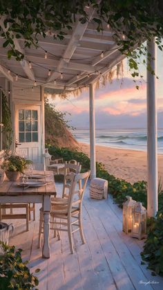 an outdoor dining table and chairs on a porch overlooking the ocean at sunset with candles lit