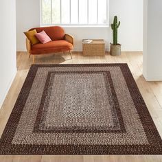 a living room with a couch, chair and rug