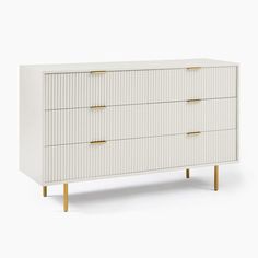 a white dresser with two gold handles and three drawers on the bottom, against a white background