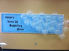 a bulletin board with balloons attached to it and the words jesus's love is bubbling over