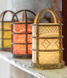 several lanterns are lined up on a shelf