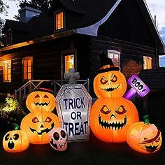 halloween decorations in front of a house at night