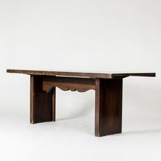 a wooden table sitting on top of a white floor