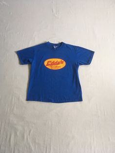 "vintage 1990s t-shirt Eddy's Groceries Olympia, WA Hanes Beefy T, 100% pre-shrunk cotton blue w/yellow/red print good vintage condition, light wear-light fade spots-see photos label size adult L-see below measures, lying flat, shoulder-19\" sleeve-7 1/2\" chest-20 11/2\" length-27\"" Blue Vintage Clothes, 90s Shirts Vintage, Vintage 90s Aesthetic Outfits, Vintage T-shirt, Vintage T Shirt Design, 90s Clothes, Class Shirt, Corner Store, Future Clothes