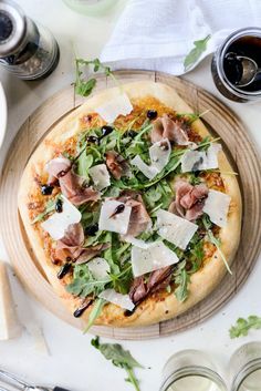 a pizza sitting on top of a wooden plate