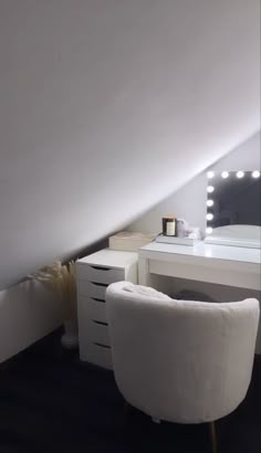 a white chair sitting in front of a desk with a mirror on it's side