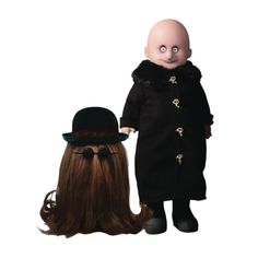 the doll is standing next to another doll with long brown hair and wearing a black coat